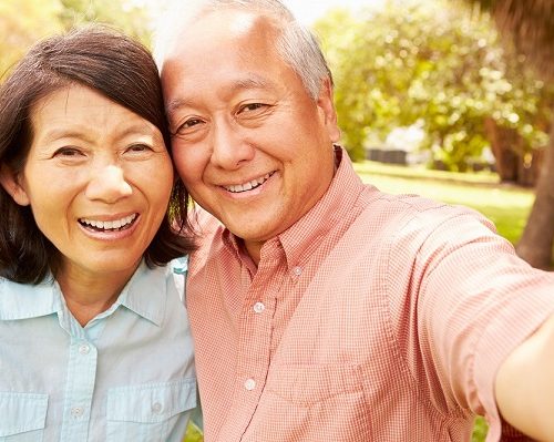 Senior,Asian,Couple,Taking,Selfie,In,Park,Together